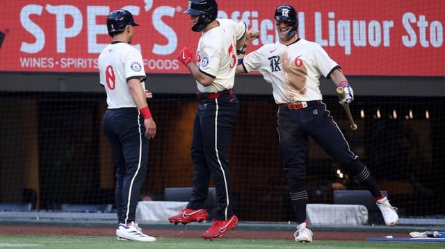 May 30, 2025; Arlington, Texas, USA; Texas Rangers outfielder Wyatt Langford (36) is congratulated after hitting a two-run home run by outfielder Sam Haggerty (0) and third base Josh Jung (6) during the second inning against the St. Louis Cardinals at Globe Life Field. Mandatory Credit: Tim Heitman-Imagn Images