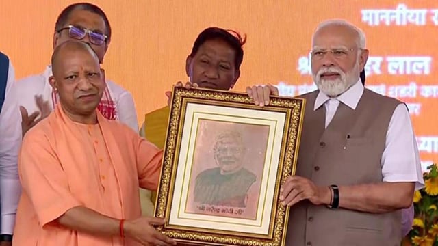 Prime Minister Narendra Modi and chief minister Yogi Adityanath at a public meeting in Kanpur on Friday. (ANI PHOTO)