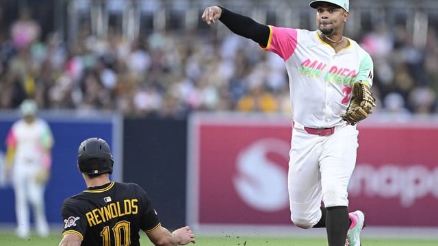May 30, 2025; San Diego, California, USA; San Diego Padres shortstop Xander Bogaerts (2) throws over Pittsburgh Pirates right fielder Bryan Reynolds (10) during the fourth inning at Petco Park. Mandatory Credit: Denis Poroy-Imagn Images