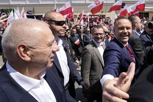 Conservative presidential candidate Karol Nawrocki, front right, takes part in a march one week ahead of a decisive election in Warsaw Poland on Sunday, May 25, 2025. (AP Photo/Czarek Sokolowski)