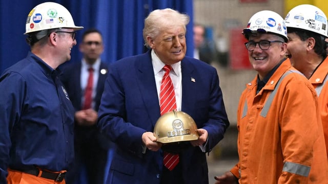 President Trump receives a gold helmet with his name on it during a visit to US Steel in Pennsylvania