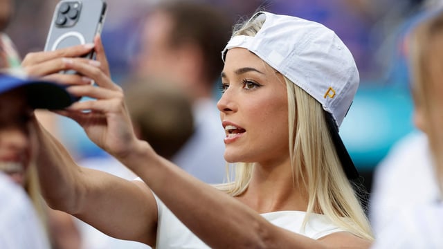 NEW YORK, NEW YORK - MAY 12: Livvy Dunne takes a photograph as she attends a game between the New York Mets and the Pittsburgh Pirates at Citi Field on May 12, 2025 in New York City. Jim McIsaac/Getty Images/AFP (Photo by Jim McIsaac / GETTY IMAGES NORTH AMERICA / Getty Images via AFP)