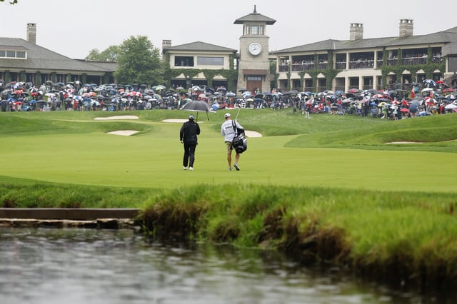 Scottie Scheffler of the United States and caddie Ted Scott walk to the 18th green during the second round of the Memorial Tournament presented by Workday 2025 at Muirfield Village Golf Club on May 30, 2025 in Dublin, Ohio.