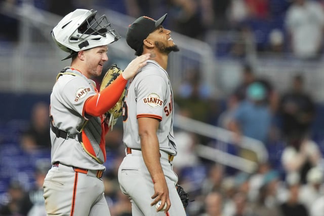 Giants catcher Patrick Bailey, left, pats relief pitcher Camilo Doval, right, on the back after the Giants defeated the Marlins, Friday, May 30, 2025, in Miami. 