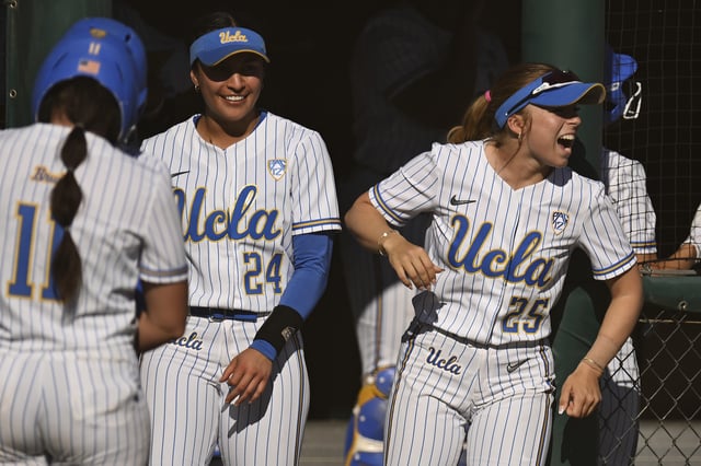 Mia McNulty #25 and Thessa Malau&#39;ulu #24 of the UCLA Bruins celebrate from the dugout against the Stanford Cardinal in the fourth inning at Boyd &amp; Jill Smith Family Stadium on April 20, 2024 in Stanford, California.