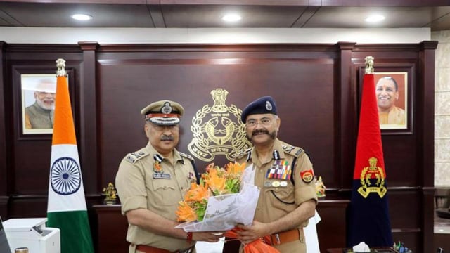 New UP Director General of Police Rajeev Krishna, left, with outgoing DGP Prashant Kumar after he assumed charge of the office, in Lucknow on Saturday. (PTI PHOTO)