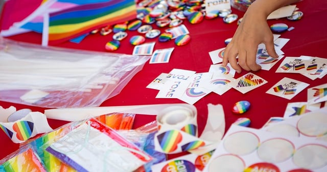 Pride flags, stickers and masks, pronoun buttons and other merch are handed out at the AISD "Pride Out!" Party in the Park event at Eastside Early College High School in Austin on March 26, 2022.