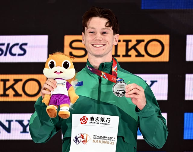 Athletics - World Athletics Indoor Championships - Nanjing Youth Olympic Sports Park, Nanjing, China - March 22, 2025 Australia's Lachlan Kennedy celebrates on the podium with a silver medal after finishing second in the men's 60m final REUTERS/Dylan Martinez/File photo