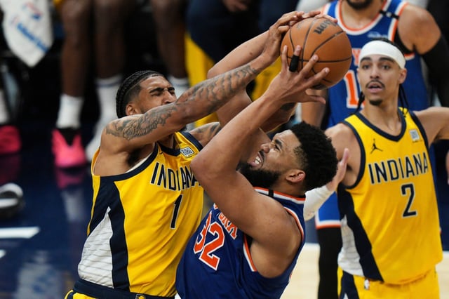 Indiana Pacers forward Obi Toppin (1) fouls New York Knicks center Karl-Anthony Towns (32) during the second half of Game 6 of the Eastern Conference finals of the NBA basketball playoffs in Indianapolis, Saturday, May 31, 2025. (AP Photo/AJ Mast)