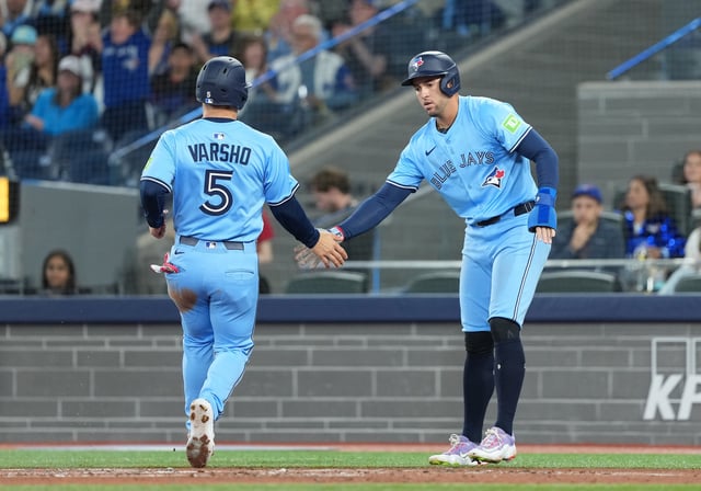 May 31, 2025; Toronto, Ontario, CAN; Toronto Blue Jays designated hitter  George Springer (4) and center fielder Daulton Varsho (5) celebrate scoring runs against the Athletics during the first inning at Rogers Centre. Mandatory Credit: Nick Turchiaro-Imagn Images