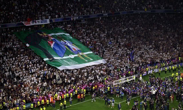Fans of Paris Saint-Germain display a banner in tribute to Xana Martinez, daughter of Luis Enrique, after PSG beat FC Internazionale to secure Paris Saint-Germain's first ever UEFA Champions League title Saturday in Munich.