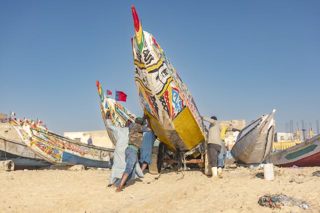 Fishermen park their pirogues after returning from fishing in Saint-Louis, Senegal, Thursday, March 13, 2025. (AP Photo/Sylvain Cherkaoui)