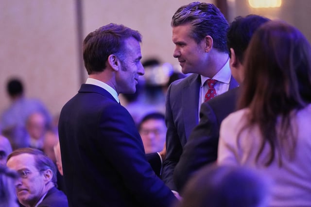 French President Emmanuel Macron, left, and U.S. Defense Secretary Pete Hegseth talk during the 22nd Shangri-La Dialogue summit in Singapore, Friday, May 30, 2025. (AP Photo/Anupam Nath)