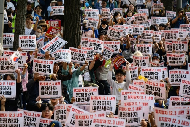 People hold placards that read 'Let's not forget the December 3 insurrection' during a campaign rally ahead of South Korea's June 3 poll
