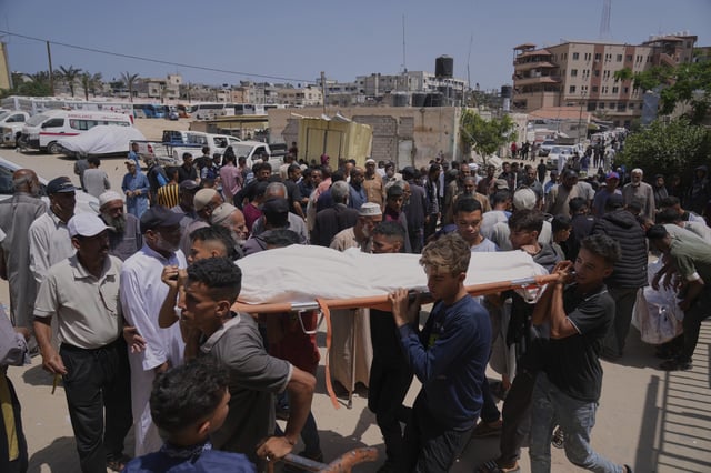 Palestinians carry the body of a person who was killed while heading to a Gaza aid hub, during a funeral at the Nasser Hospital in Khan Younis, southern Gaza Strip, Sunday, June 1, 2025.