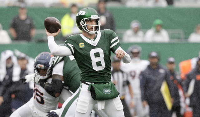 Aaron Rodgers #8 of the New York Jets in action against the Denver Broncos at MetLife Stadium on September 29, 2024 in East Rutherford, New Jersey.