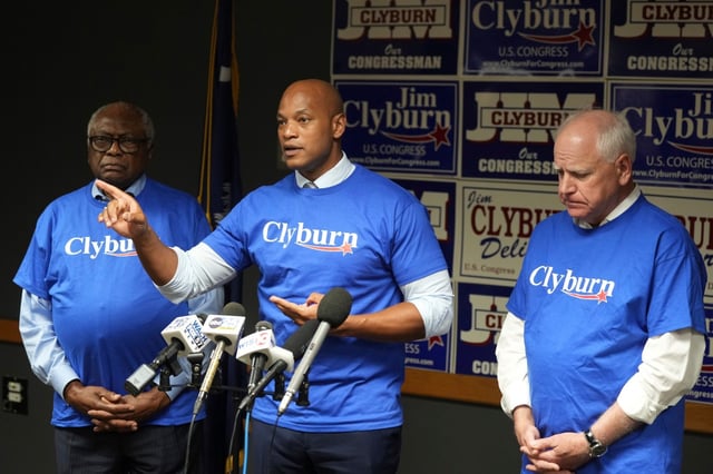 Maryland Gov. Wes Moore speaks to reporters as Rep. Jim Clyburn, D-S.C., left, and Minnesota Gov. Tim Walz look on at Clyburn&#39;s World Famous Fish, Friday, May 30, 2025, in Columbia, S.C. (AP Photo/Meg Kinnard)