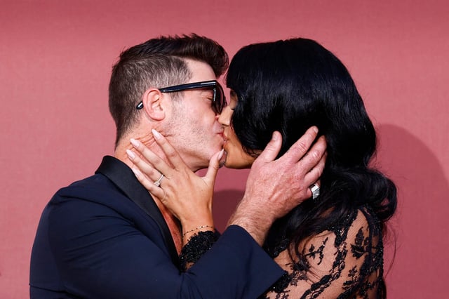 Robin Thicke kisses April Love Geary during the Cannes Film Festival on May 23, 2024.