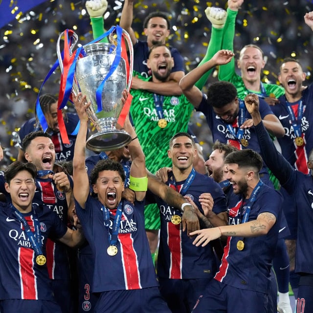 PSG players celebrate with the trophy after winning the Champions League final soccer match between Paris Saint-Germain and Inter Milan at the Allianz Arena in Munich, Germany, Saturday, May 31, 2025. (AP Photo/Matthias Schrader)