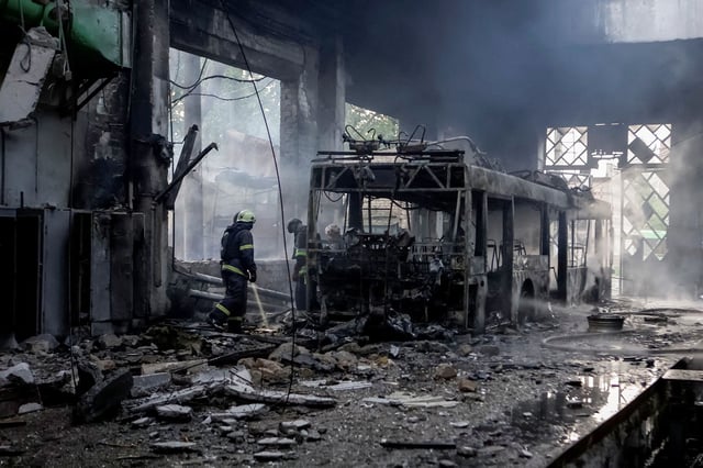 Rescuers work at a site of a trolleybus depot, hit by a Russian drone strike in Kharkiv, Ukraine, on Friday.