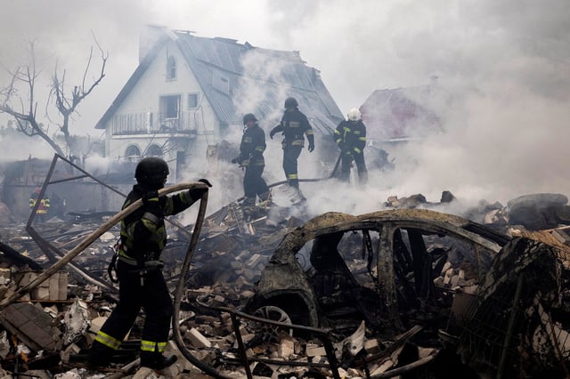 Emergency workers extinguish flames in the debris of a private house that was destroyed in a Russian rocket strike in Markhalivka, Kyiv region, Ukraine, on May 25.