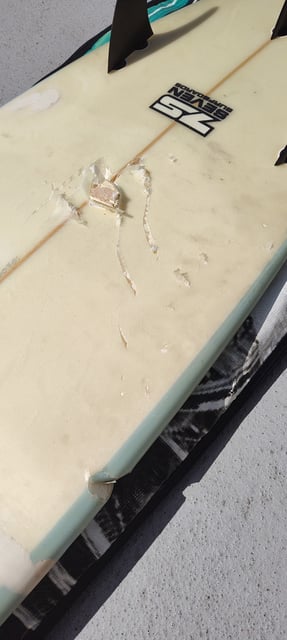Heller shows where a shark bit his surfboard Saturday while he was surfing at Montara State Beach in San Mateo County. 