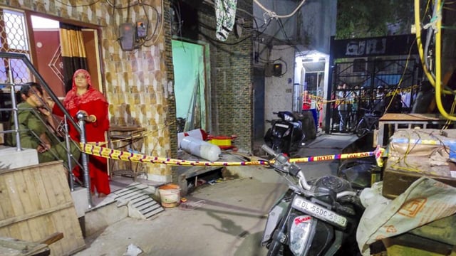 The locality with the building where the ground floor was used as a godown in Sunder Nagri on Saturday. (PTI)