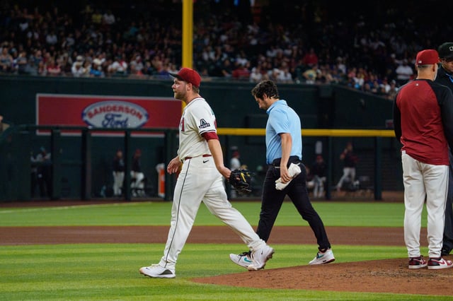 Jun 1, 2025; Phoenix, Arizona, USA; Arizona Diamondbacks starting pitcher Corbin Burnes (39) reacts after an injury in the fith inning and leaves the field against the Washington Nationals at Chase Field. Mandatory Credit: Allan Henry-Imagn Images