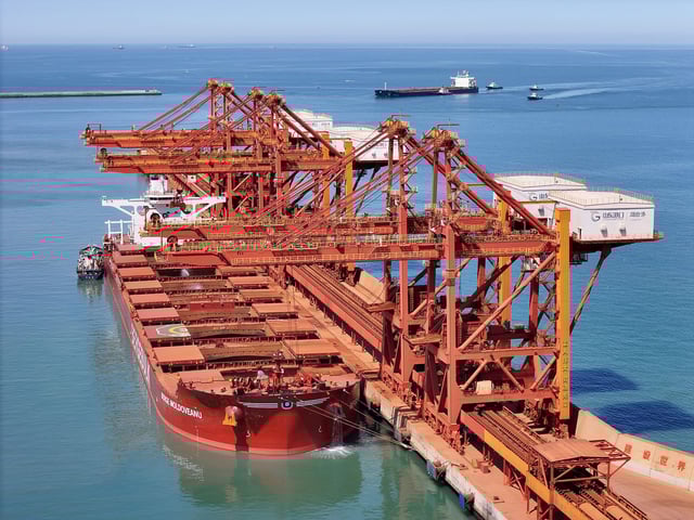 A cargo ship unloads at the ore terminal in the West Port Area of Yantai Port in Shandong province, China, on April 25, 2025.