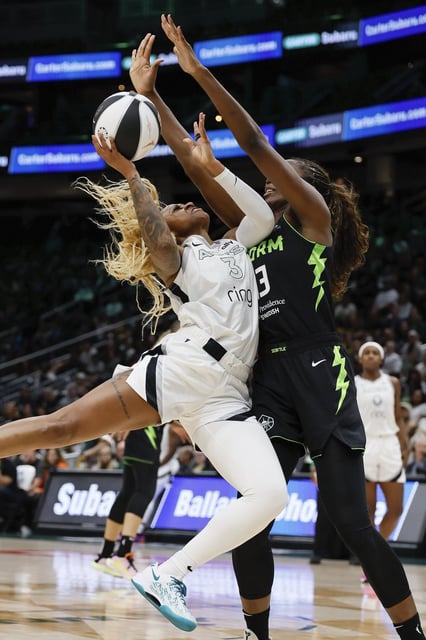 Las Vegas Aces guard Tiffany Mitchell , left, has her shot blocked by Seattle Storm forward Ezi Magbegor, right, during the second quarter of a WNBA basketball game Sunday, June 1, 2025, in Seattle. (Jennifer Buchanan/The Seattle Times via AP)