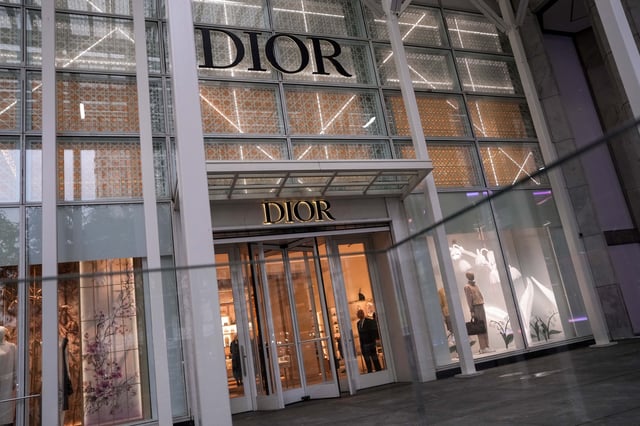A security guard looks out from the store of French luxury goods company Dior on 5th Avenue in New York City, U.S., May 23, 2025. REUTERS/Adam Gray/File Photo