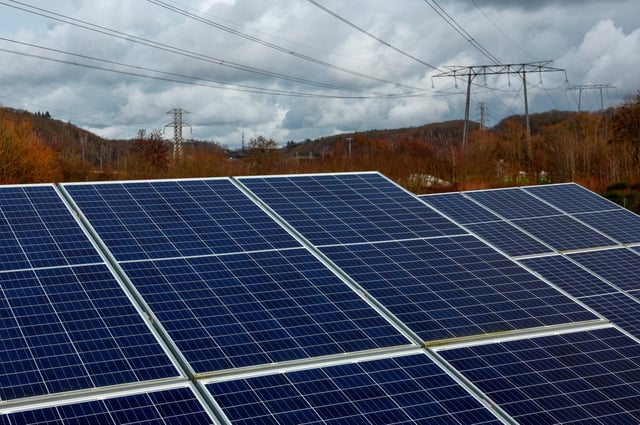 Pylons of high-tension electricity power lines are seen near solar panels at the photovoltaic park installed by Engie in Marcoussis near Paris, France, February 12, 2024. REUTERS/Gonzalo Fuentes/File Photo