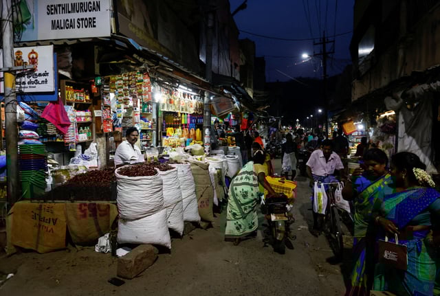People walk along a street market in Tiruvannamalai, India, April 17, 2024. REUTERS/Navesh Chitrakar/File Photo