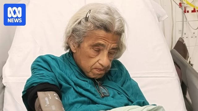 An elderly woman in a hospital bed