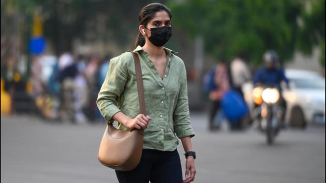 People step out wearing face masks amid a resurgence of the Covid-19 outbreak. (Sunil Ghosh/ HT Photo)