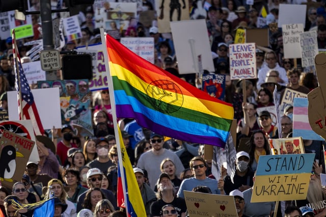 A protester holds a rainbow flag during the nationwide &#34;Hands Off!&#34; protest against US President Donald Trump and his advisor, Tesla CEO Elon Musk, in downtown Los Angeles on April 5, 2025.