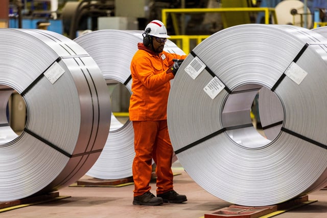 A worker inspects a steel coil on the factory floor before Canada's Prime Minister-designate Mark Carney visits the ArcelorMittal Dofasco steel mill in Hamilton, Ontario, Canada March 12, 2025.  REUTERS/Carlos Osorio/File Photo