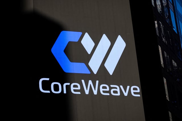 A screen displays the company logo for CoreWeave, Inc., Nvidia-backed cloud services provider, during the company's IPO at the Nasdaq Market, in New York City, U.S., March 28, 2025. REUTERS/Brendan McDermid