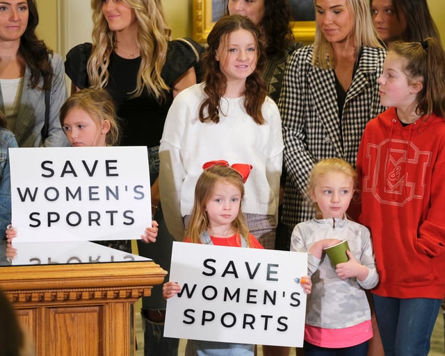 Guests witness Oklahoma Gov. Kevin Stitt signing the Save Women in Sports Act in Oklahoma City on March 30, 2022.