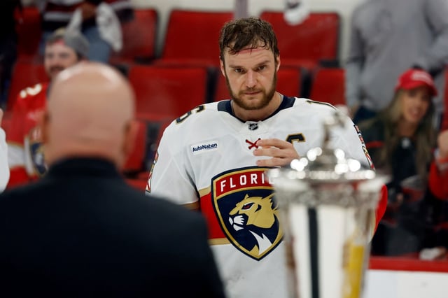 Florida Panthers&#39; Aleksander Barkov (16) skates over to accept the Prince of Wales Trophy following Game 5 of the NHL hockey Stanley Cup Eastern Conference finals against the Carolina Hurricanes in Raleigh, N.C., Wednesday, May 28, 2025. (AP Photo/Karl DeBlaker)