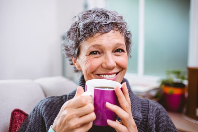 Stock image of a happy woman drinking coffee