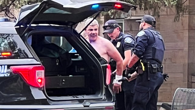 Law enforcement officers detain suspect Mohamed Sabry Soliman, after an attack that injured multiple people, in Boulder, Colorado, 