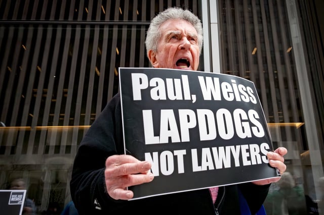 A protester outside Paul, Weiss law firm offices in New York on April 15, 2025. 