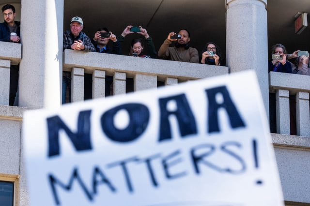 National Oceanic and Atmospheric Administration workers watch a rally outside headquarters to oppose the recent firings, in Sliver Spring, Md., on Monday, March 3, 2025. Sen. Chris Van Hollen, D-Md., and other members of Congress also attended.