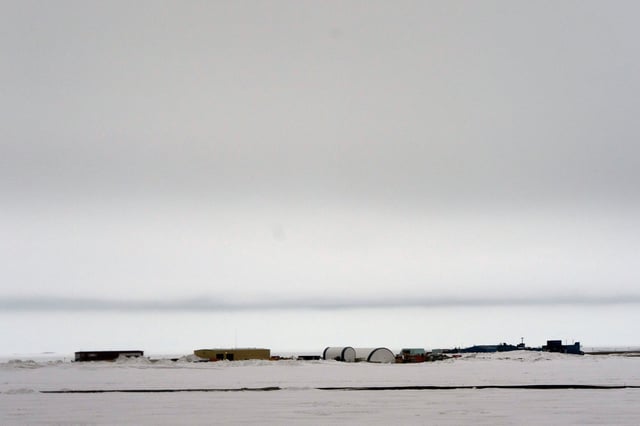 This image taken through a window of a plane shows airport buildings in Deadhorse, Alaska on Monday, June 2, 2025. (AP Photo/Jenny Kane)