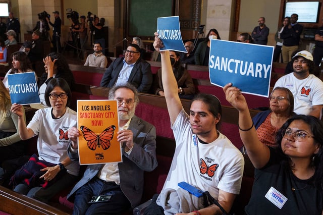 Members of immigration advocacy groups react as the Los Angeles City Council votes to enact an ordinance prohibiting city resources from being used for immigration enforcement on November 19, 2024.