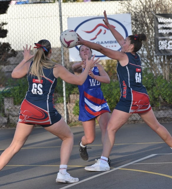 West Gambier's Sarah Ritter and Lisa McGregor make it hard for Casterton Sandford's Tessa Marra to move the ball out of the Roos' attacking third. (James Murphy: 482086)
