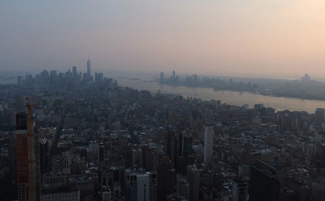 Smoke from wildfires in Canada shrouds the skyline of lower Manhattan and One World Trade Center at sunset on August 16, 2024, in New York City.