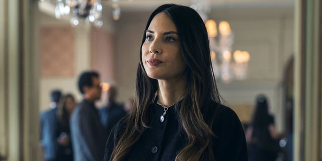Olivia Munn as Sam dress in black and looking serious at her husband's funeral in Your Friends & Neighbors