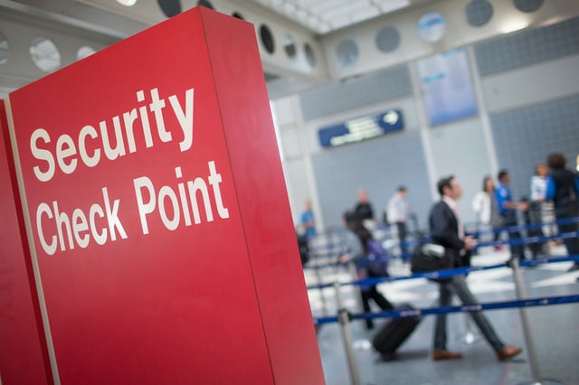 A sign directs travelers to a security checkpoint staffed by Transportation Security Administration workers at O'Hare Airport on June 2, 2015 in Chicago, Illinois.